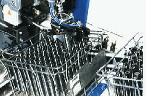 Machine tool tending with robot taking shafts from a basket